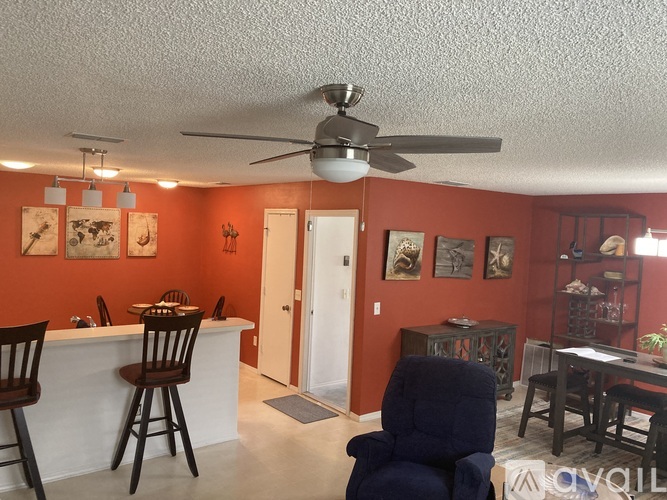 A living room with a bar and chairs.
