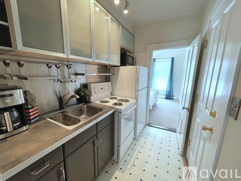 A kitchen with a sink, stove, and refrigerator.
