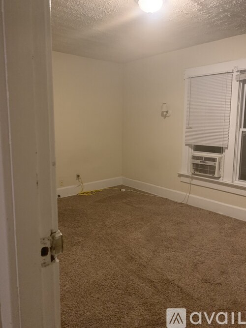 A room with a window and a door.