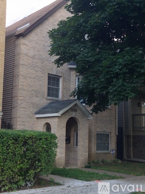A brick house with a window and a door.