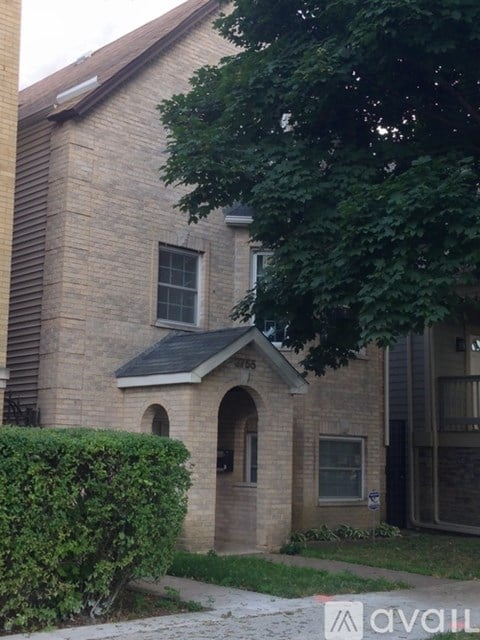 A brick house with a window and a door.