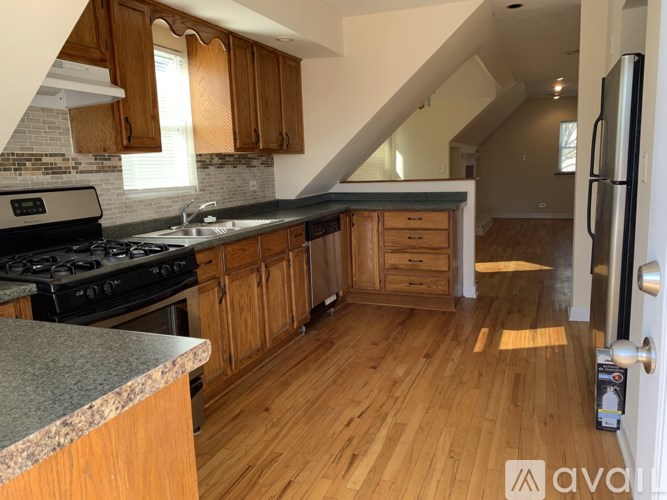 A kitchen with wooden cabinets and a black stove top oven.