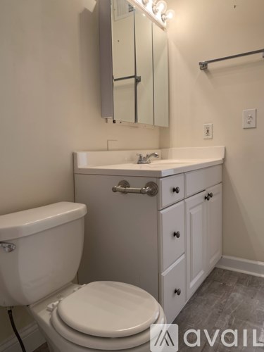 A white toilet sits next to a sink in a bathroom.