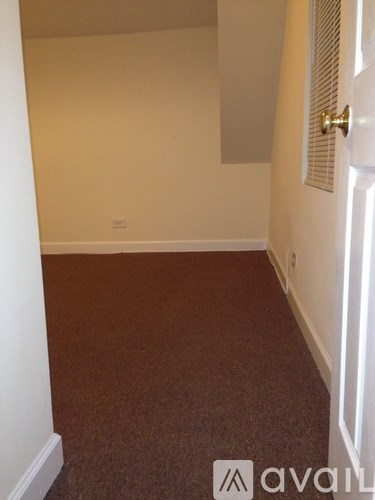 A room with a carpeted floor and a closed door.