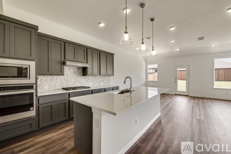 A modern kitchen with dark wood cabinets and a white island.