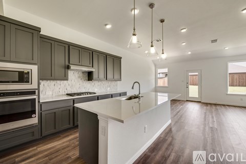 A modern kitchen with dark wood cabinets and a white island.