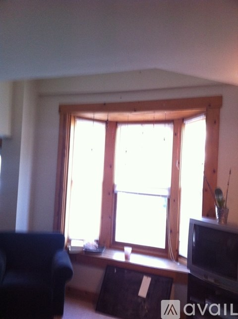 A living room with a blue couch and a television.