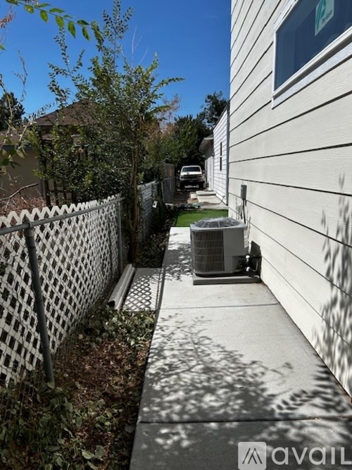 A white fence runs along the side of a house.