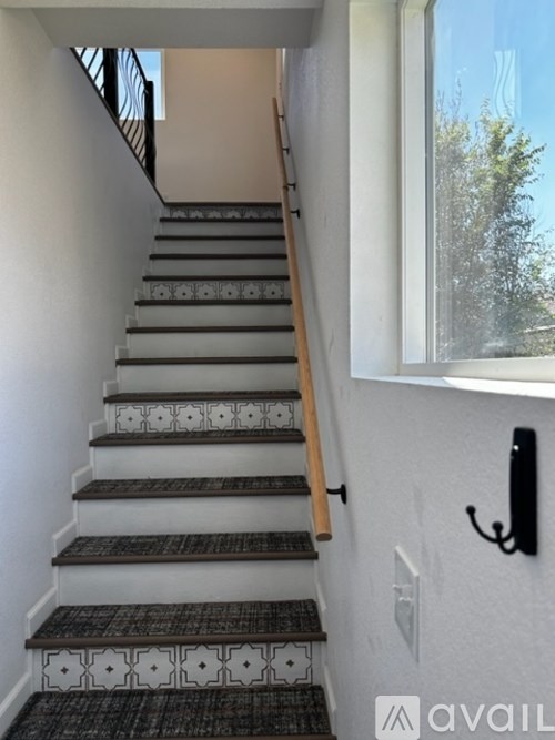 A staircase with a black and white tiled bottom step.