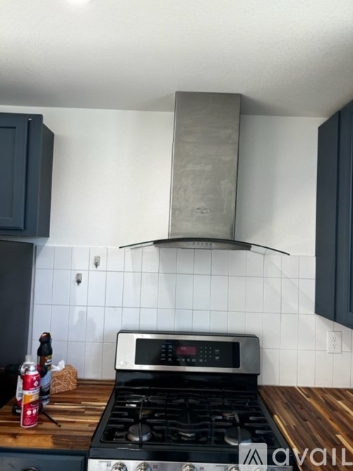 A stove top oven with a can of soda on the counter.