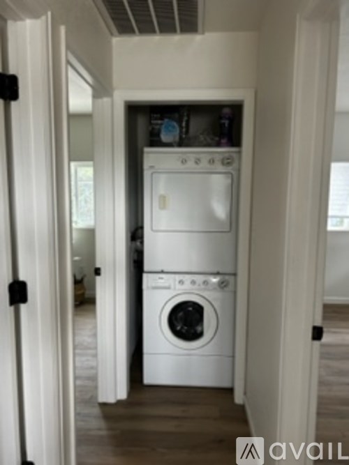 A white washing machine and dryer in a small laundry room.