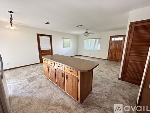 A kitchen area with a countertop and cabinets.