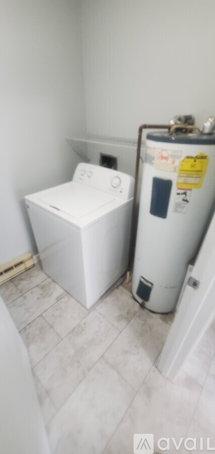A white washing machine and dryer in a small room.
