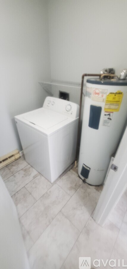 A white washing machine and dryer in a small room.