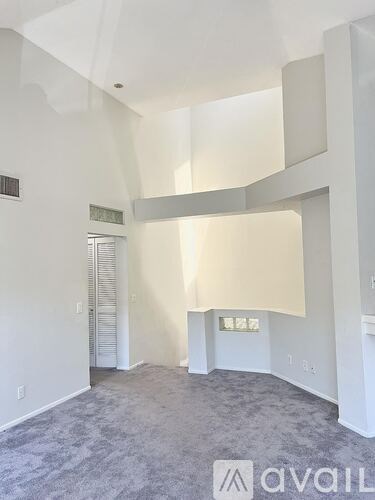 A living room with a beige couch and a wooden coffee table.