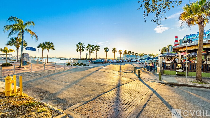 A sunny day at the beach with palm trees and a clear blue sky.