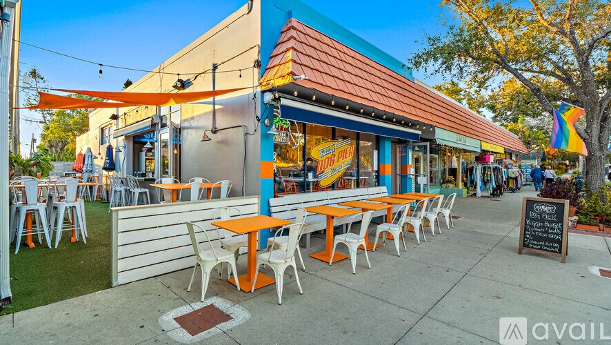 A colorful outdoor dining area with tables and chairs.