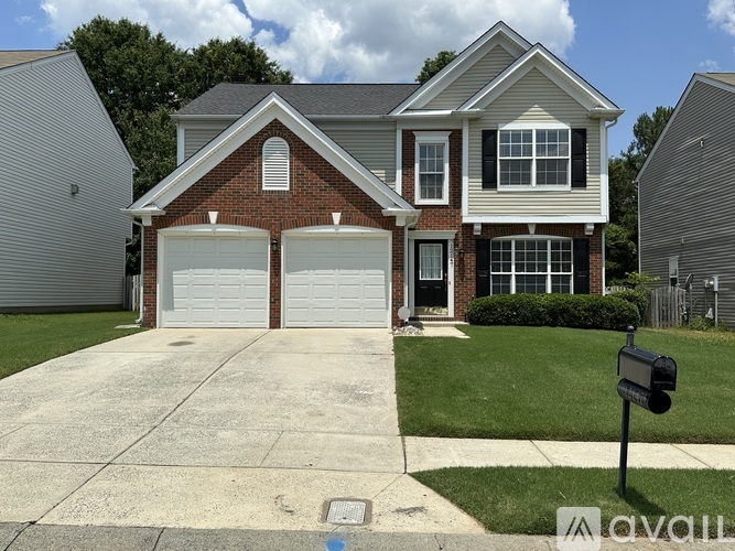 A two-story house with a brick facade and white trim.
