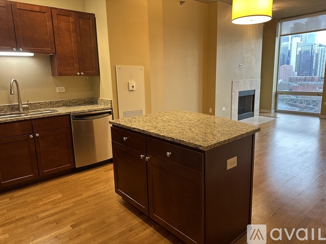 A kitchen with wooden cabinets and a granite countertop.