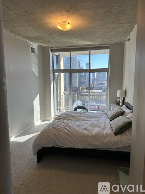 A bedroom with a large bed and a view of the city.