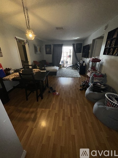 A living room with a dining table and chairs.