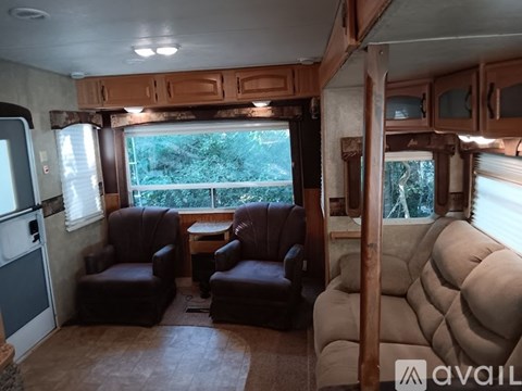 A living room with brown leather chairs and a brown couch.