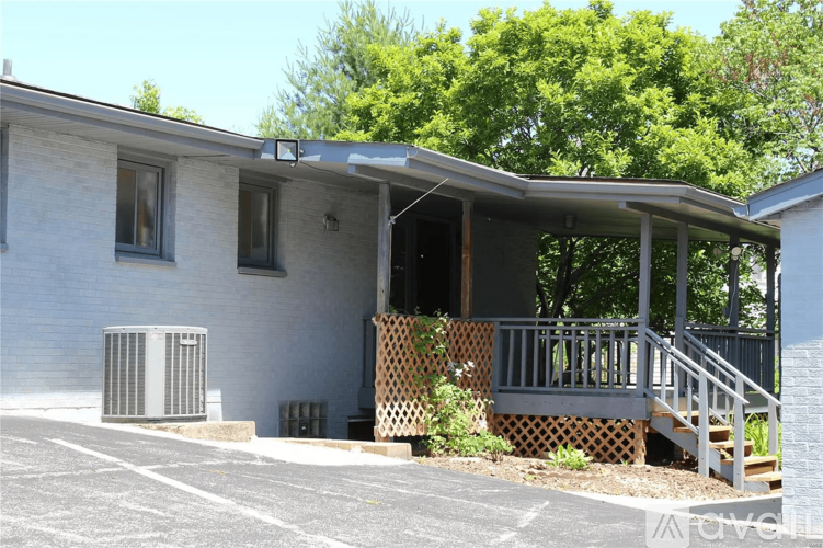 A house with a covered porch and a white exterior.