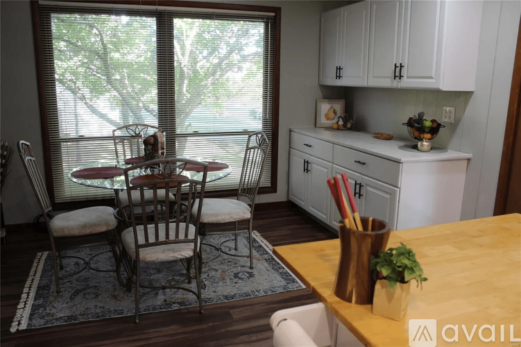 A dining room with a table set for four.