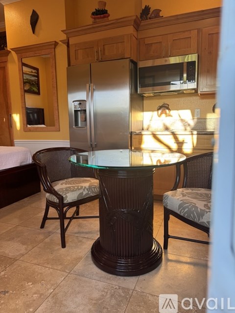 A kitchen with a table and chairs.