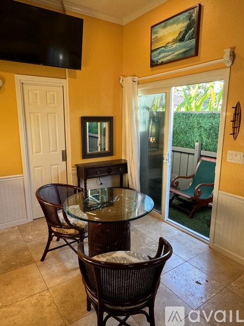 A dining room with a glass table and chairs.