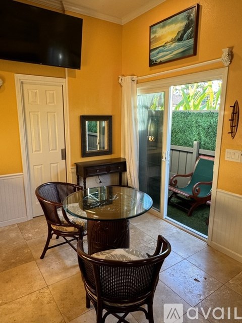 A dining room with a glass table and chairs.