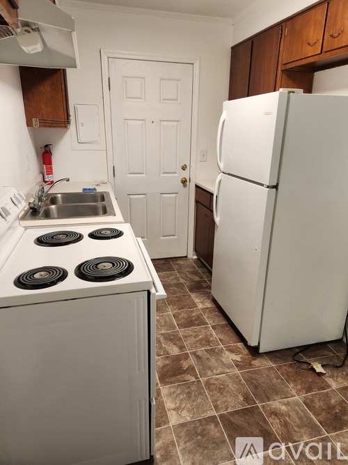A white fridge in a kitchen with a white door.