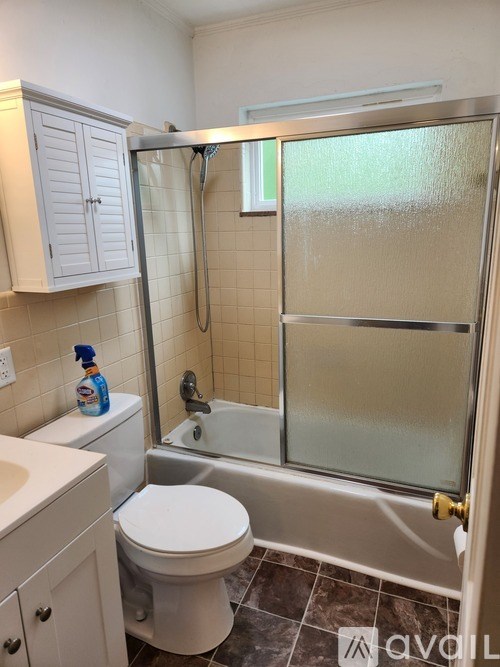 A bathroom with a toilet, sink, and shower.