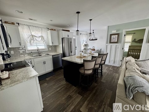 A kitchen with a table and chairs in the middle of the room.