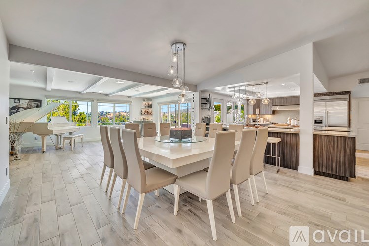 A modern dining room with a large table and chairs.