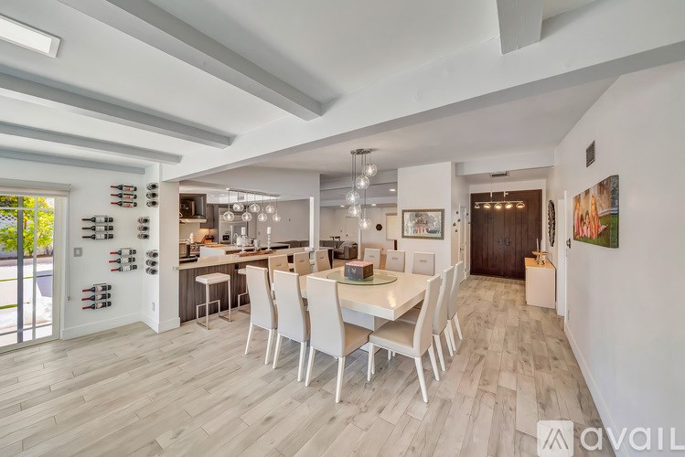 A modern kitchen with a dining table and chairs.