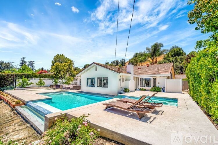 A house with a pool in the backyard.