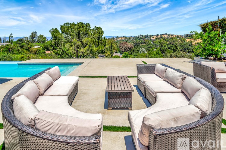 A patio with a pool and furniture.