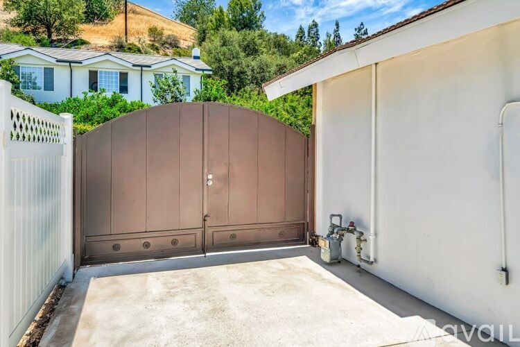 A brown gate is closed and locked.