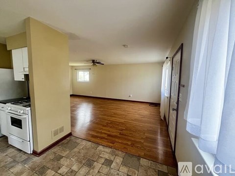 A kitchen with a stove top oven and a fan on the ceiling.