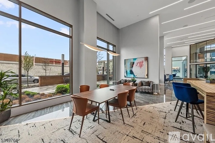 A modern dining room with a large table and chairs.