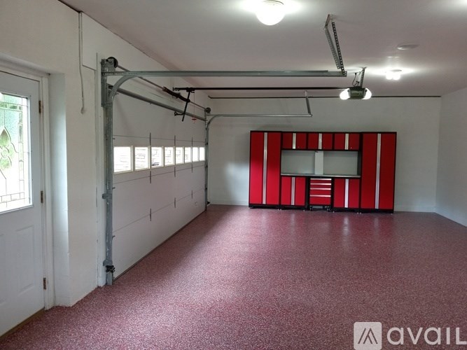 A room with a red floor and a red and white striped wall.
