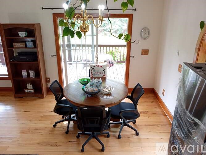 A dining room with a wooden table and chairs.