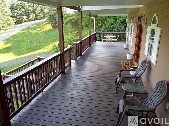 A wooden deck with chairs and a table is available for use.
