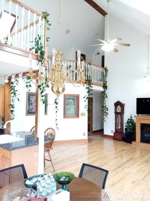 A dining room with a table set for a meal.