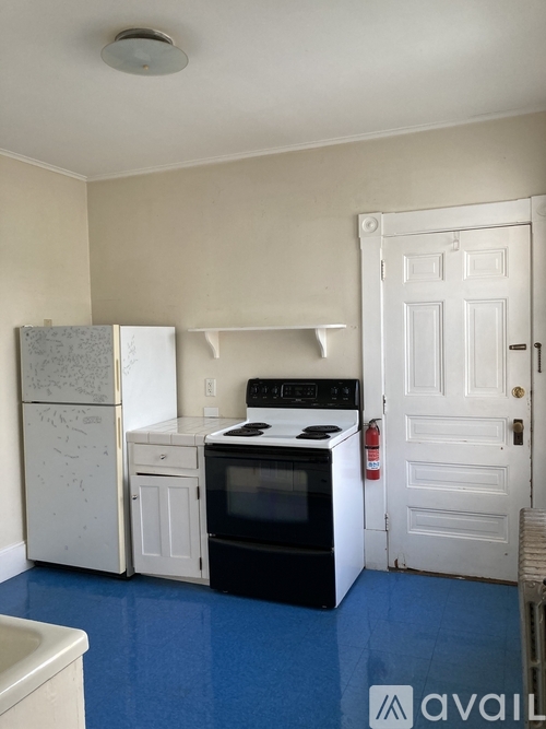 A kitchen with a white fridge, white oven, and white cabinets.