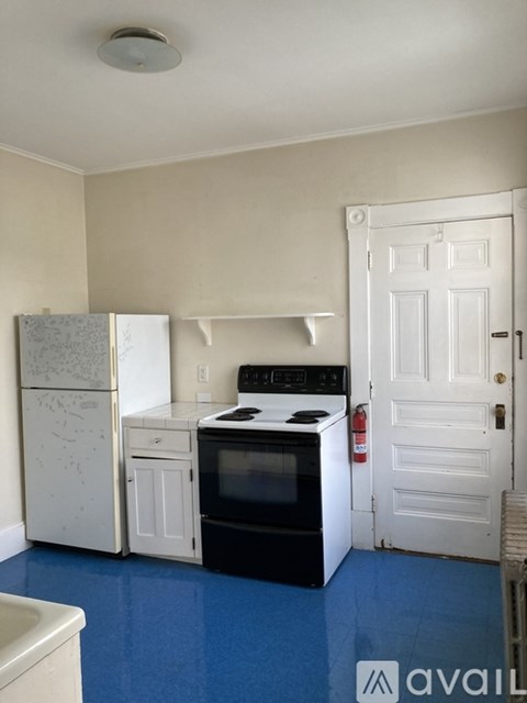 A kitchen with a white fridge, white oven, and white cabinets.