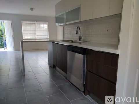 A kitchen with a stainless steel dishwasher and microwave.