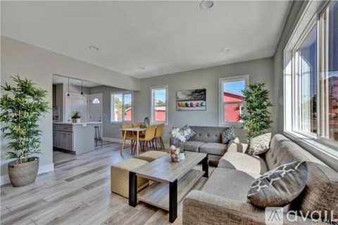 A modern living room with a grey sofa and a wooden coffee table.