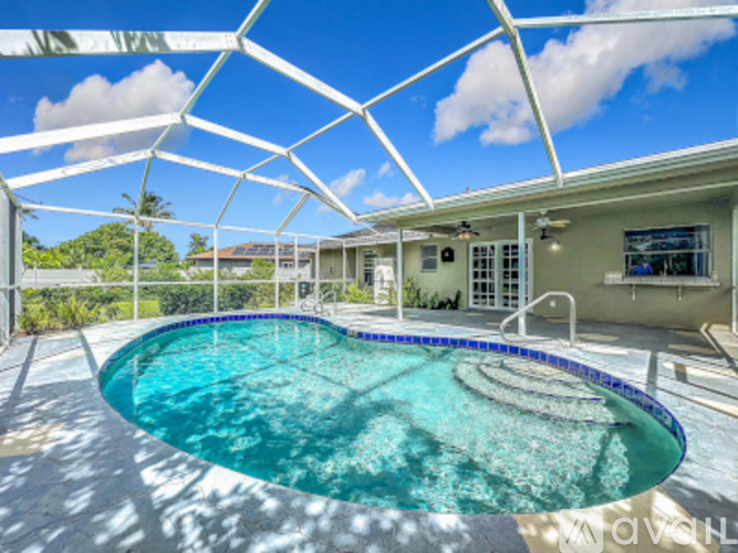 A swimming pool under a white metal structure.